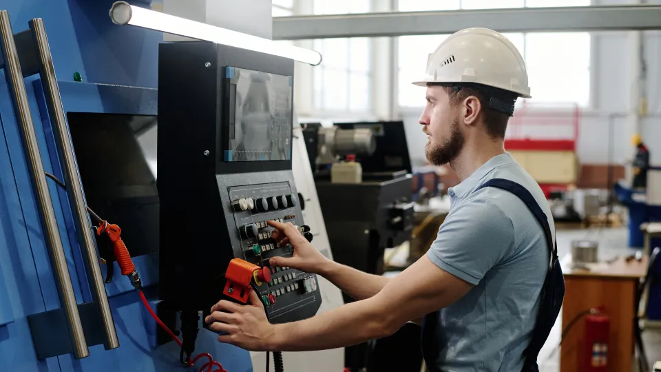 An operator in front of an equipment operating according to the manual