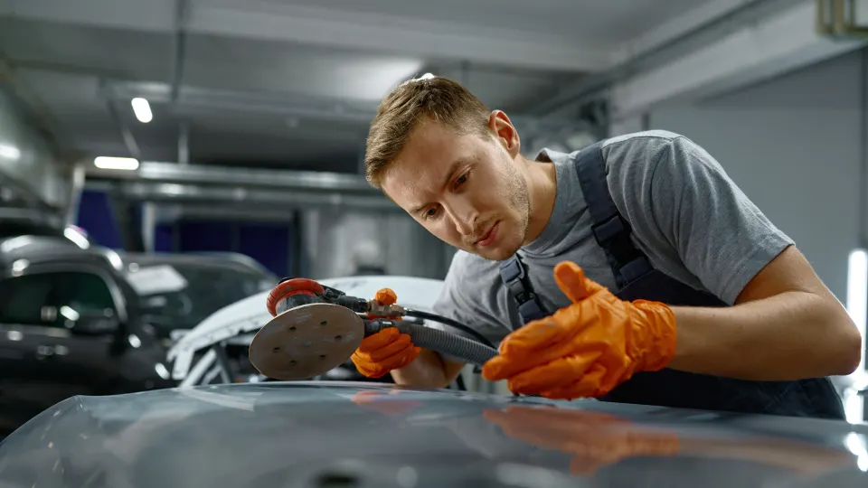 An operator checks a car in the car factory